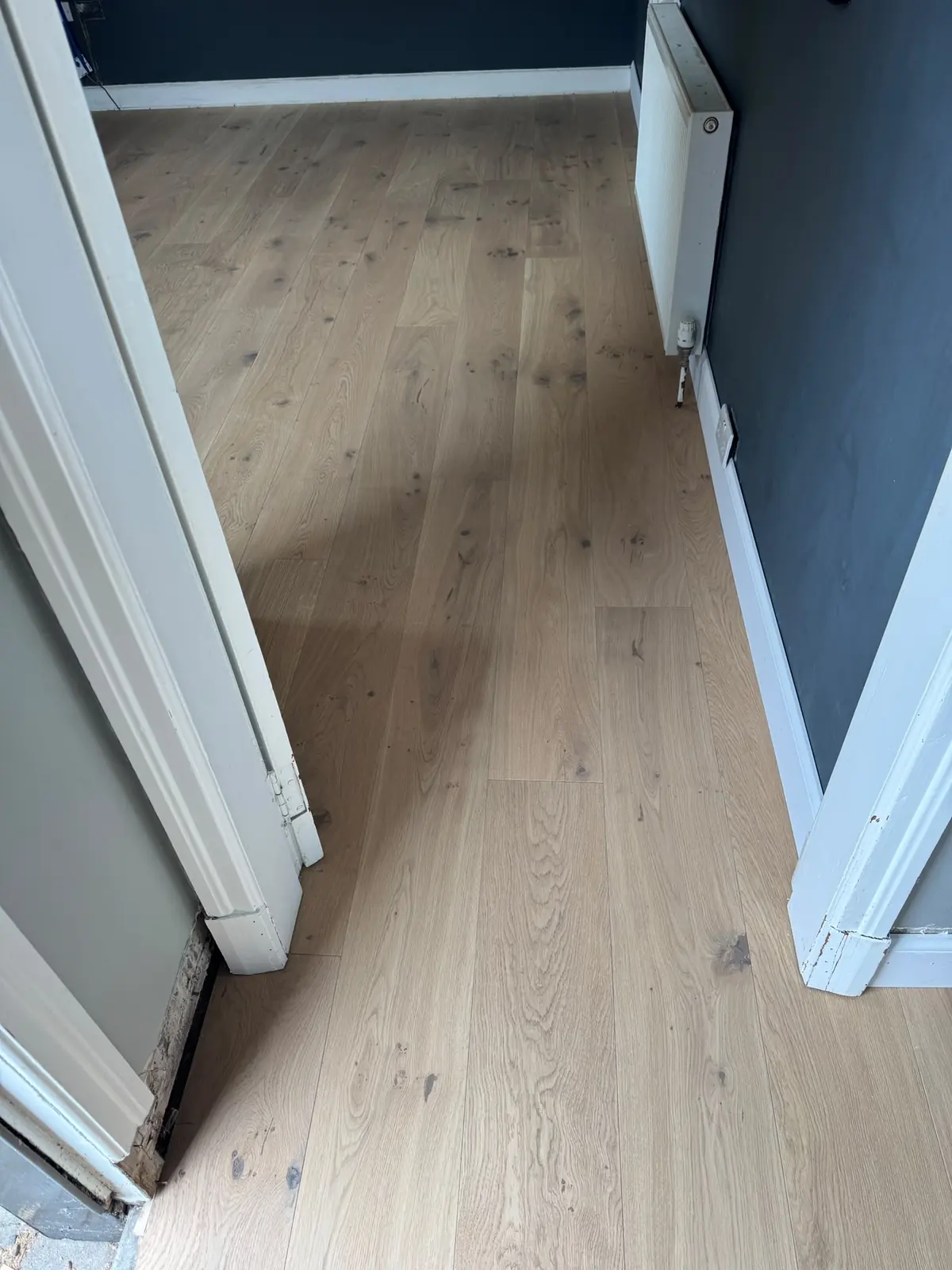 Sun Beam engineered oak flooring running from the hallway into a bedroom
