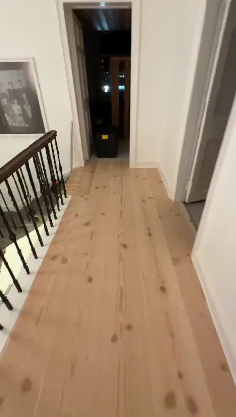 5 metre long Douglas fir planks on a landing beside a black balustrade