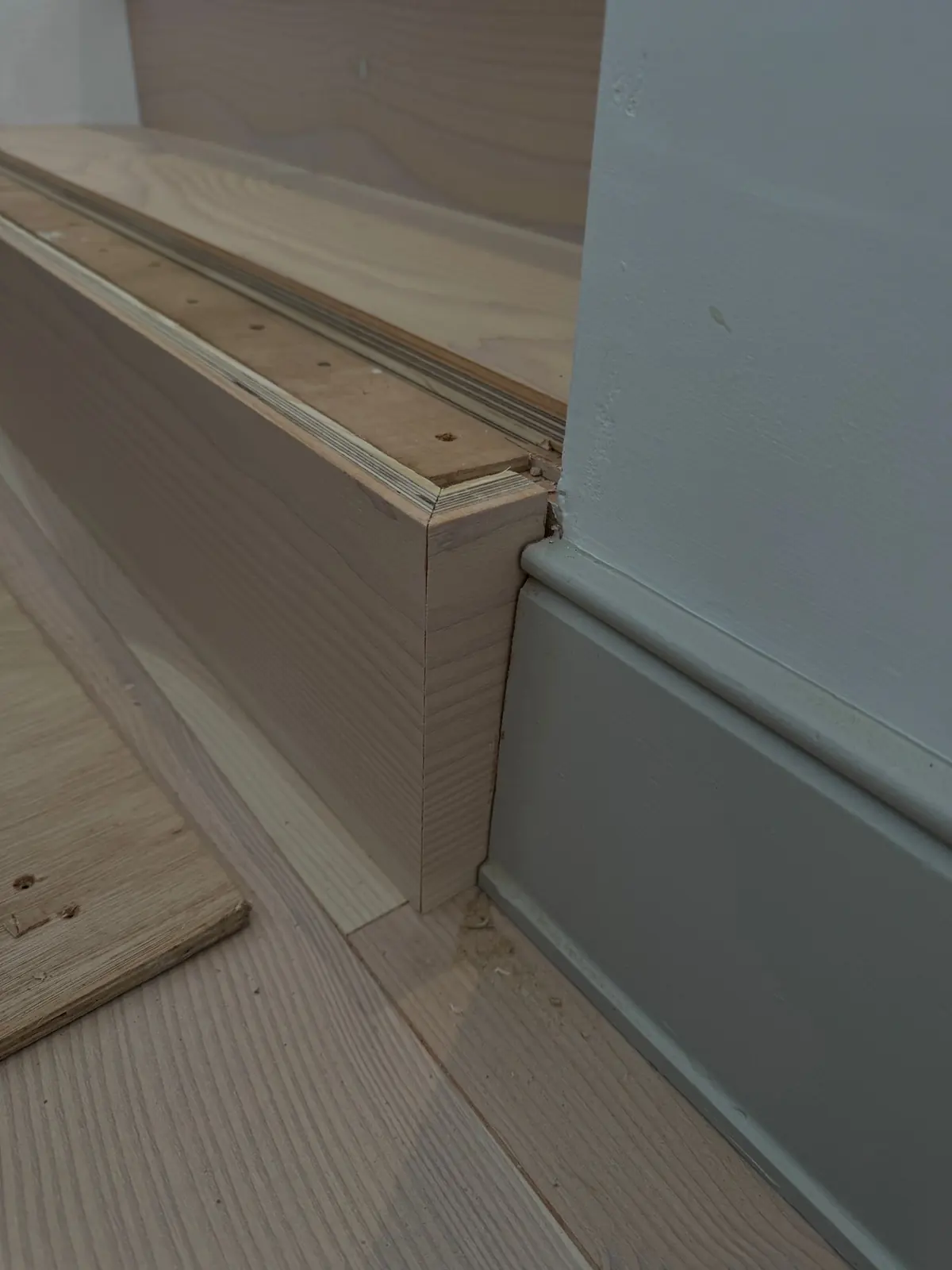 Douglas fir riser with a mitred corner meeting the skirting