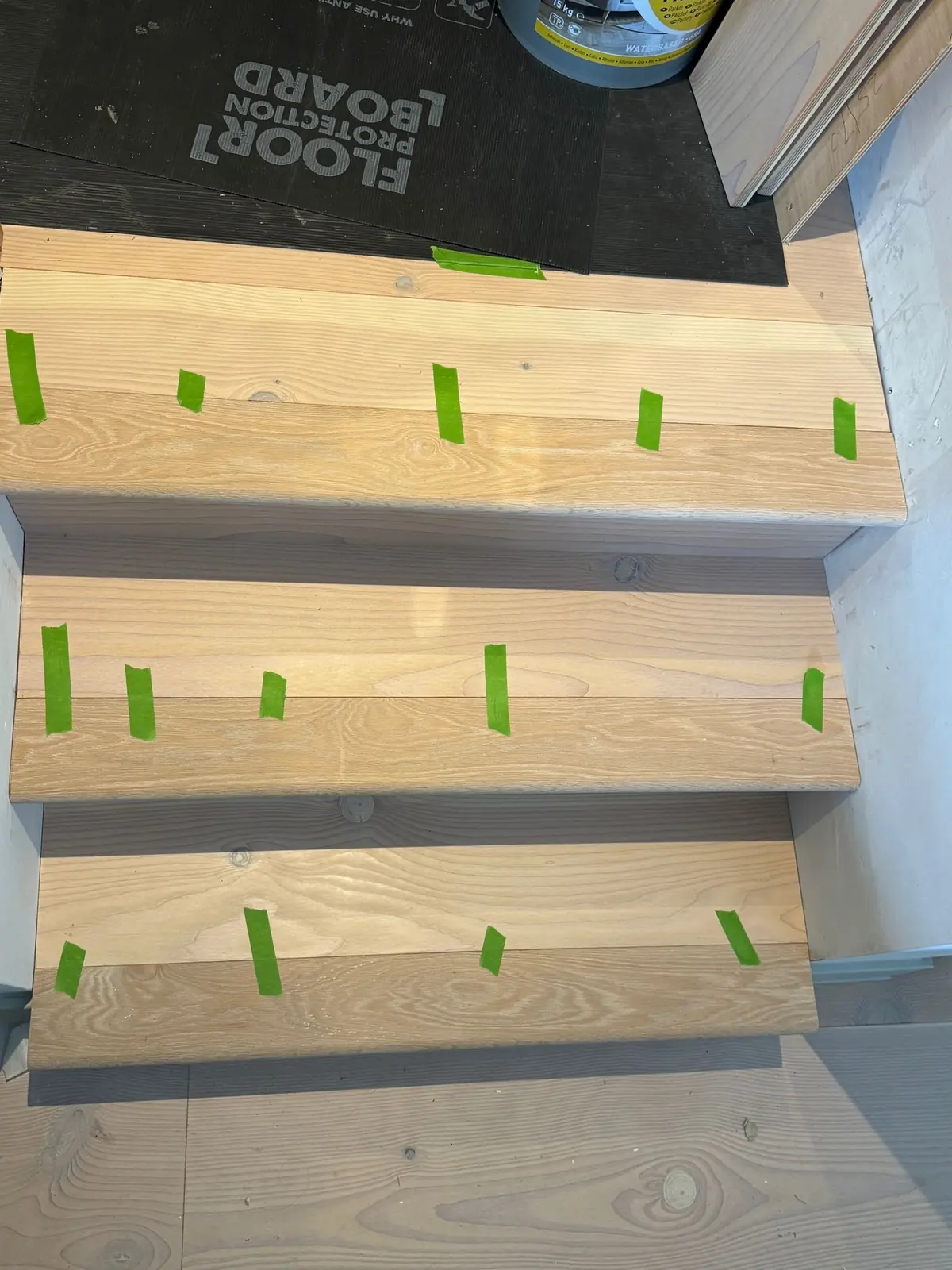 Douglas fir treads taped while the adhesive cures
