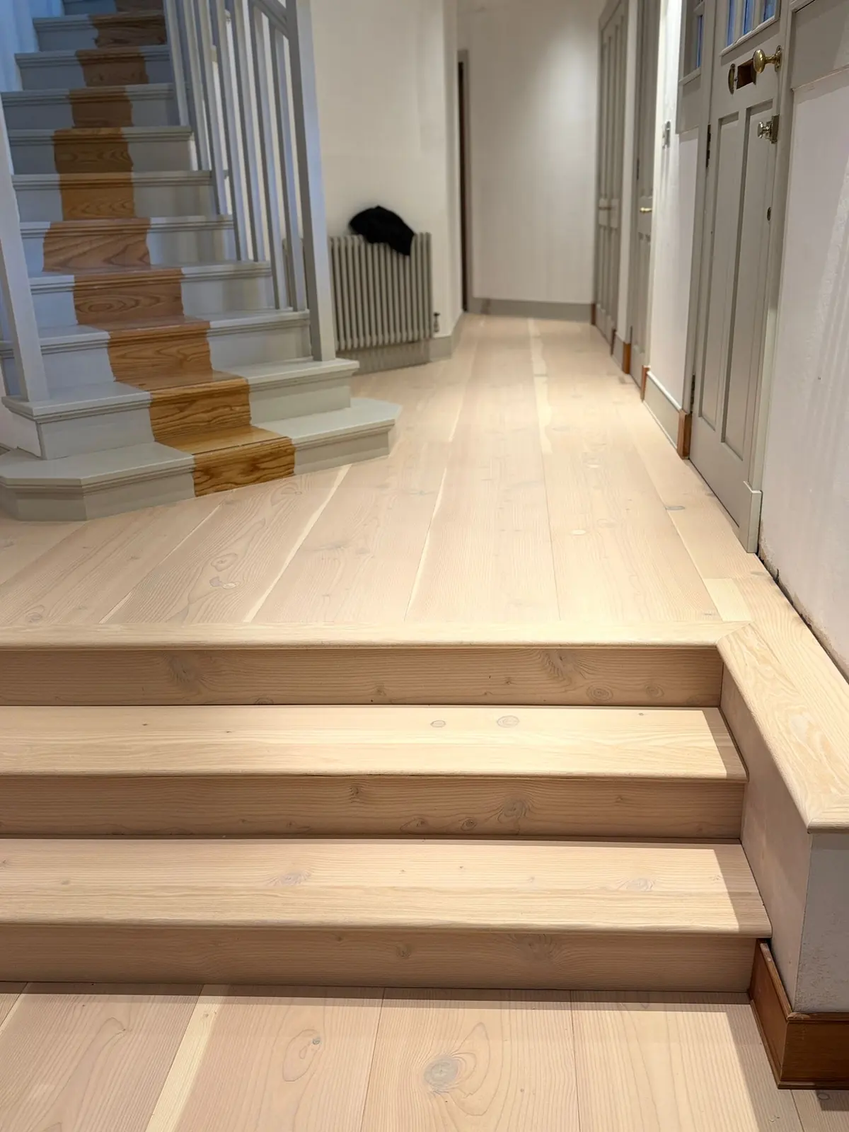 Douglas fir wide plank flooring in a hallway with steps clad in matching Douglas fir, Glasgow