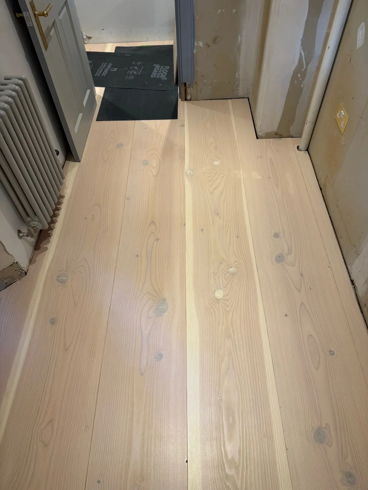 Extra-long 300mm Douglas fir planks in a bedroom in Glasgow