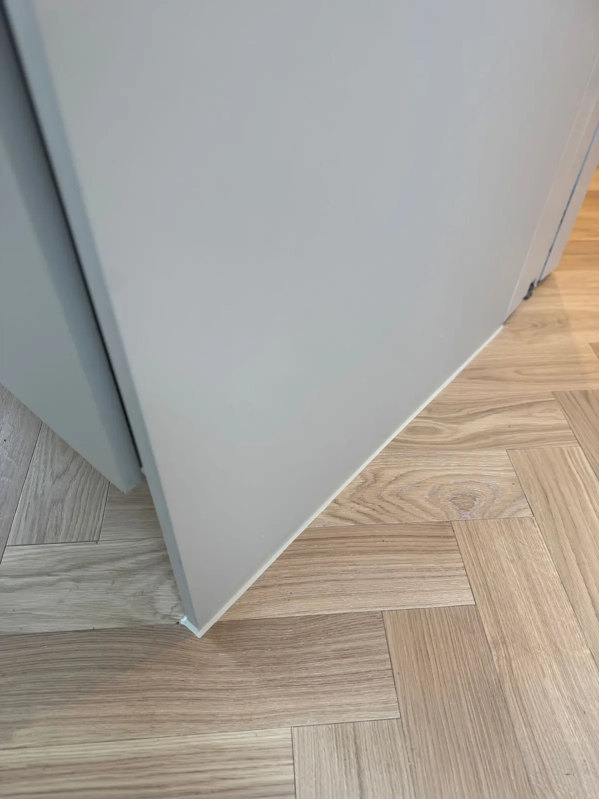 Herringbone parquet running from the original house into the new extension