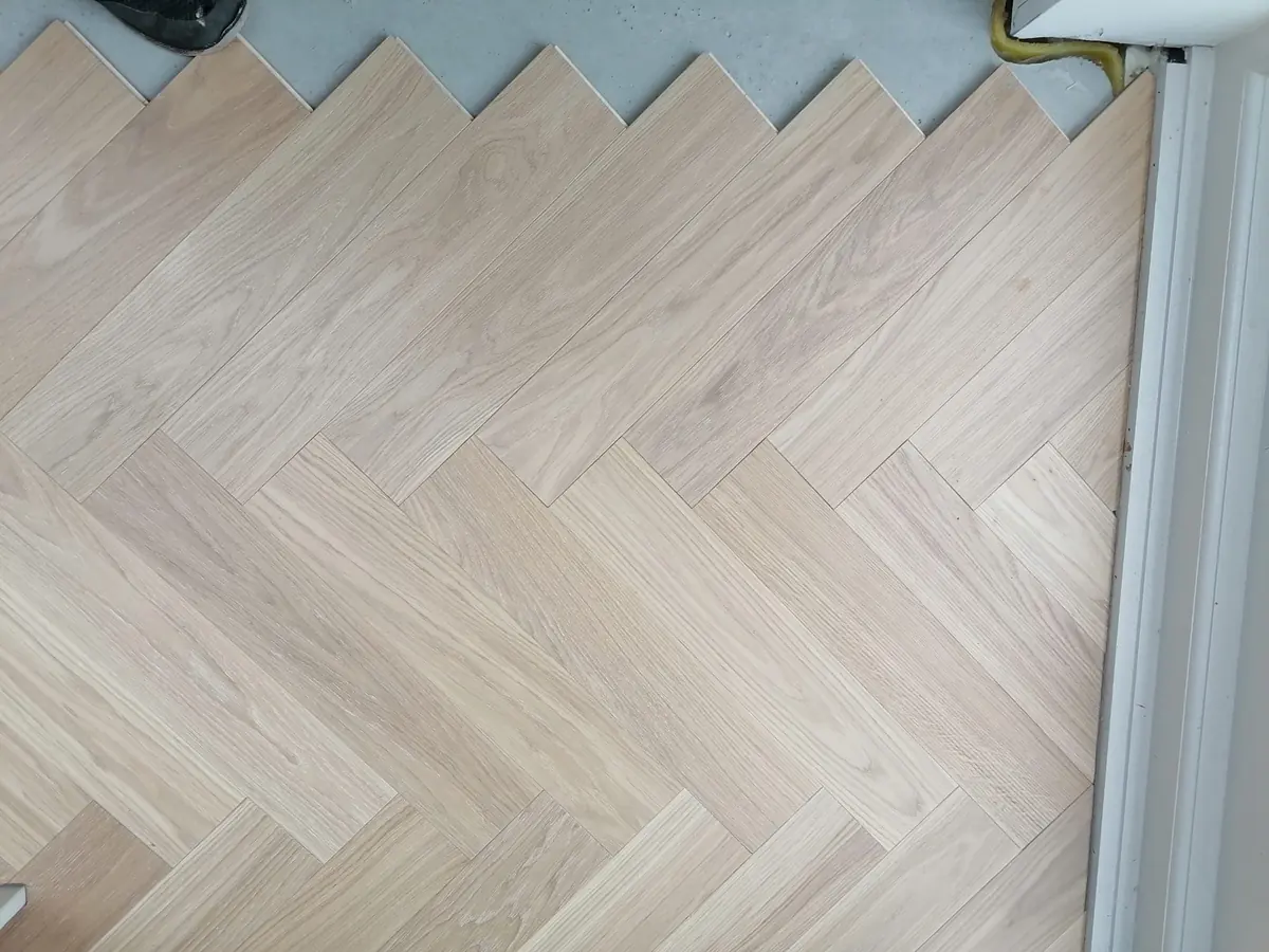 Ice Cream herringbone parquet being installed towards the garden doors