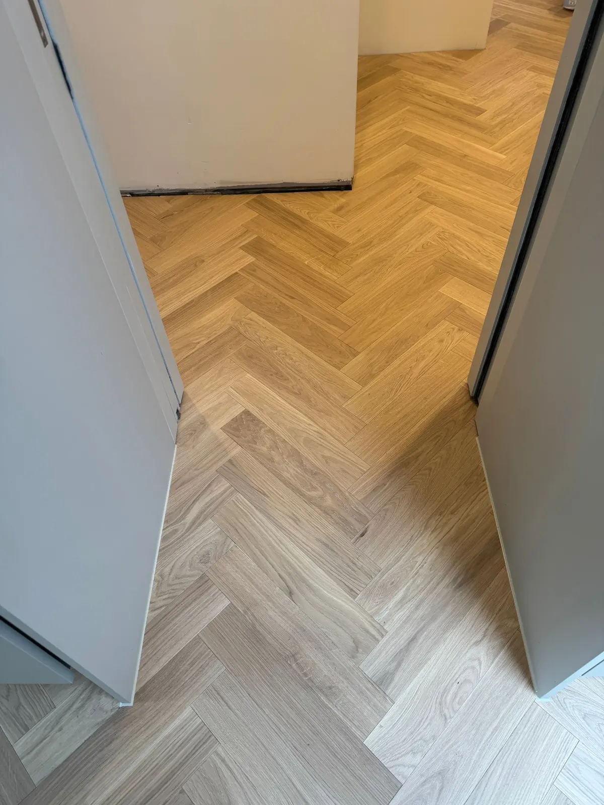 Premium grade Ice Cream herringbone parquet by the kitchen island