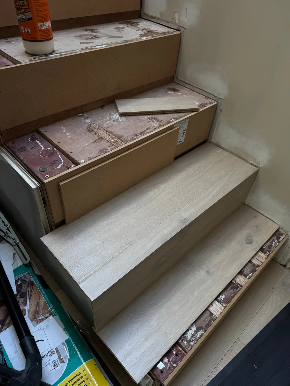 First bespoke oak tread and riser fitted over the metal stair frame