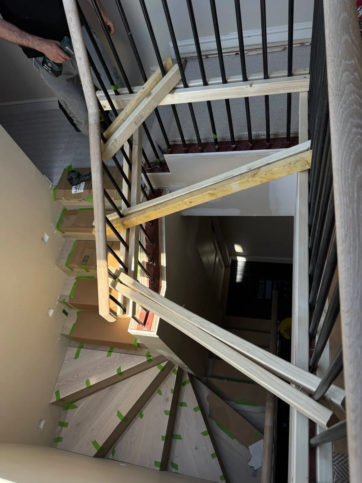 Staircase from above with temporary timber bracing holding the balustrade while spindles are re-welded
