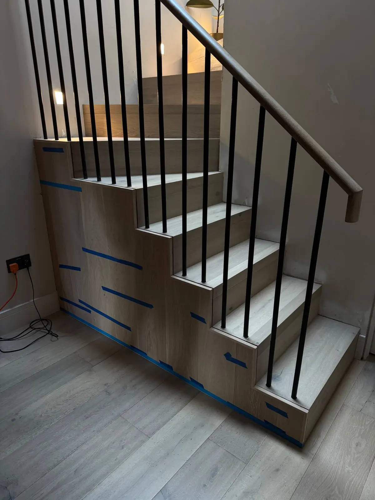 Under-stairs area panelled in oak before the slatted profiles were added