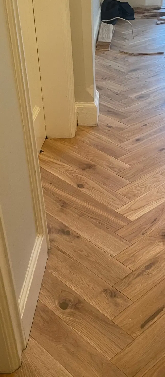 Herringbone parquet running from the hallway into the living room