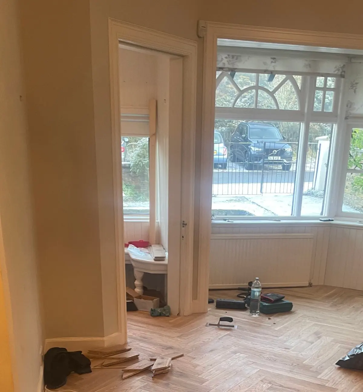 Herringbone parquet in the living room with a bay window