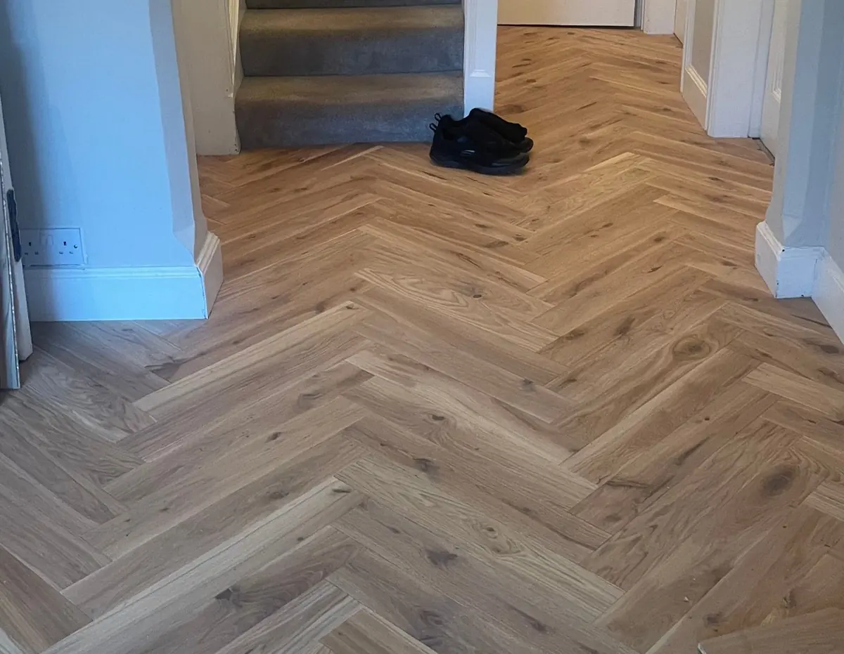 Oak herringbone parquet in the hallway at the foot of the stairs