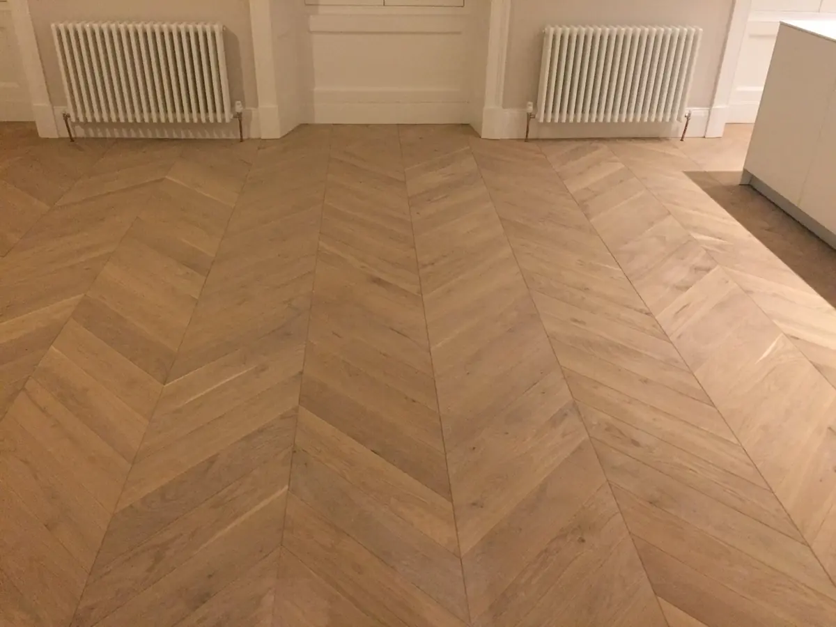 Chevron parquet between sash windows and column radiators