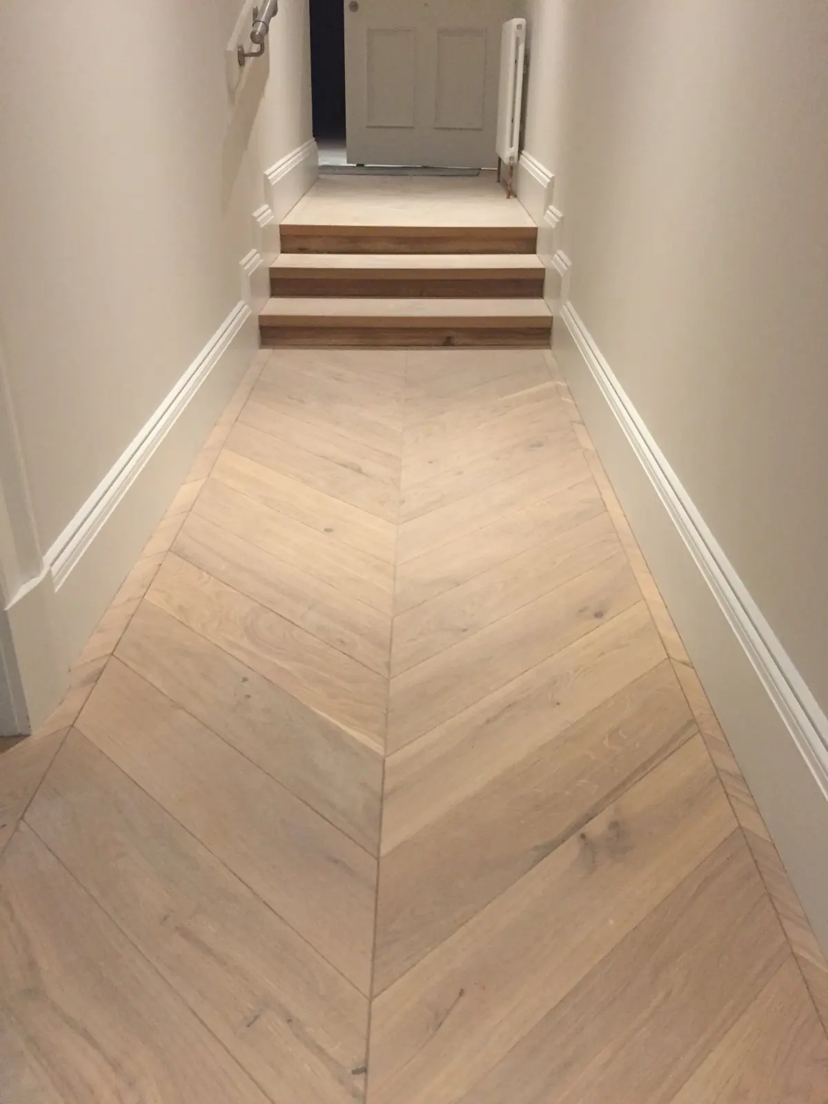 Chevron parquet in a living room with a marble fireplace in Edinburgh