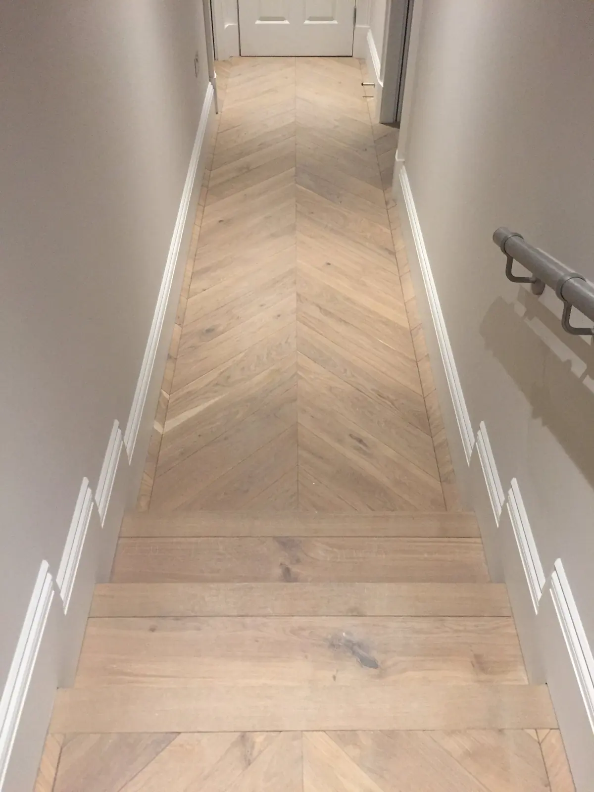 Light Oak chevron parquet beside the kitchen island