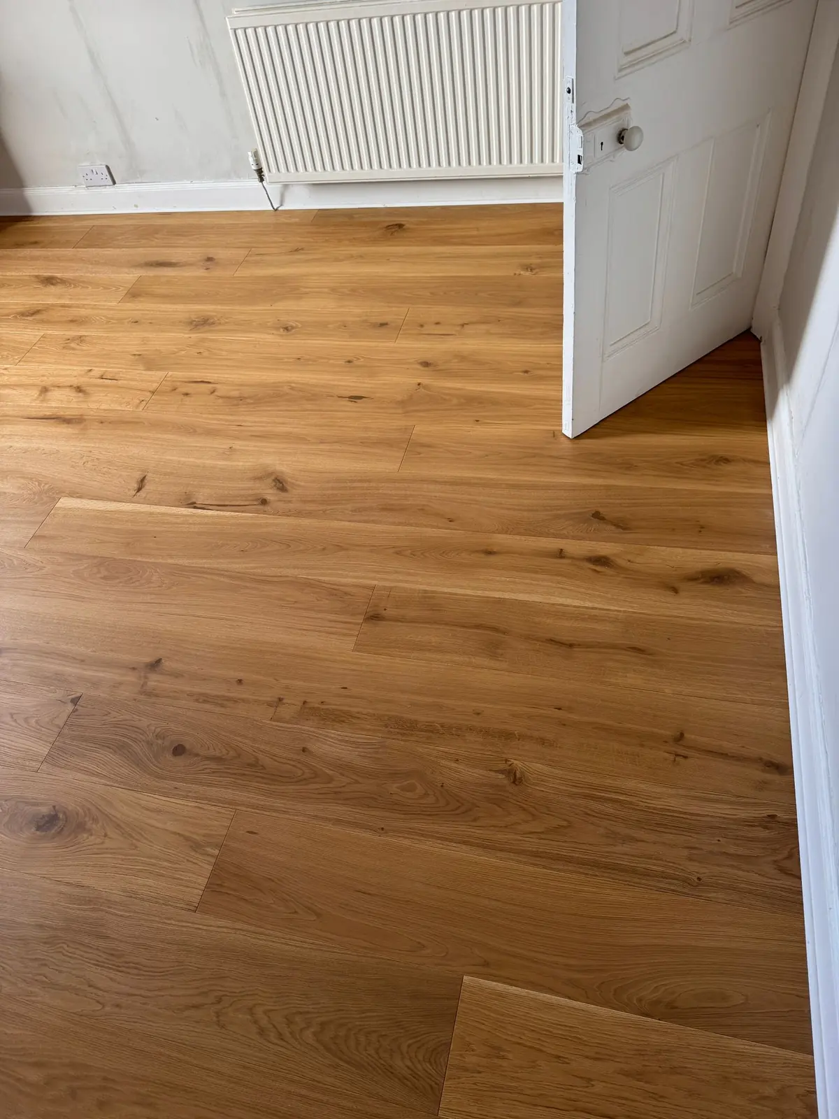 Oak floor under a trimmed bedroom door