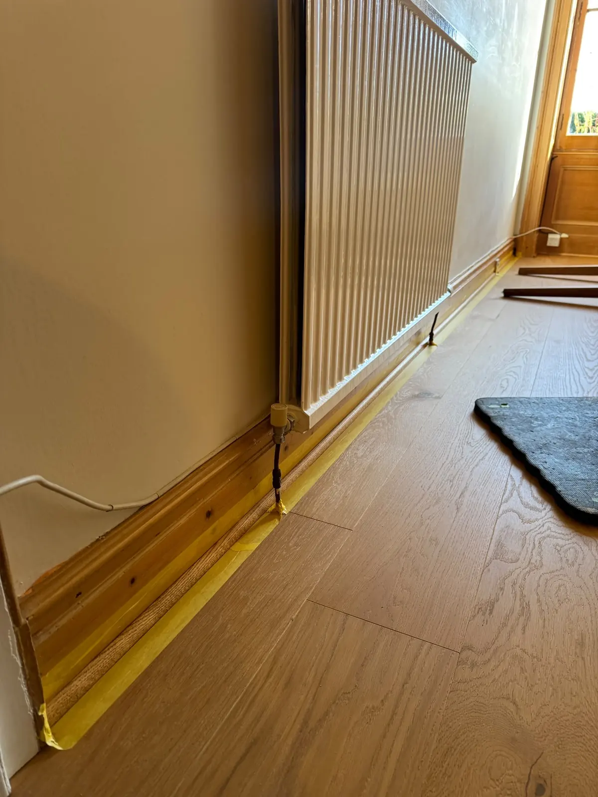 Bespoke oak quadrant beading in a matching colour, taped while it is fixed