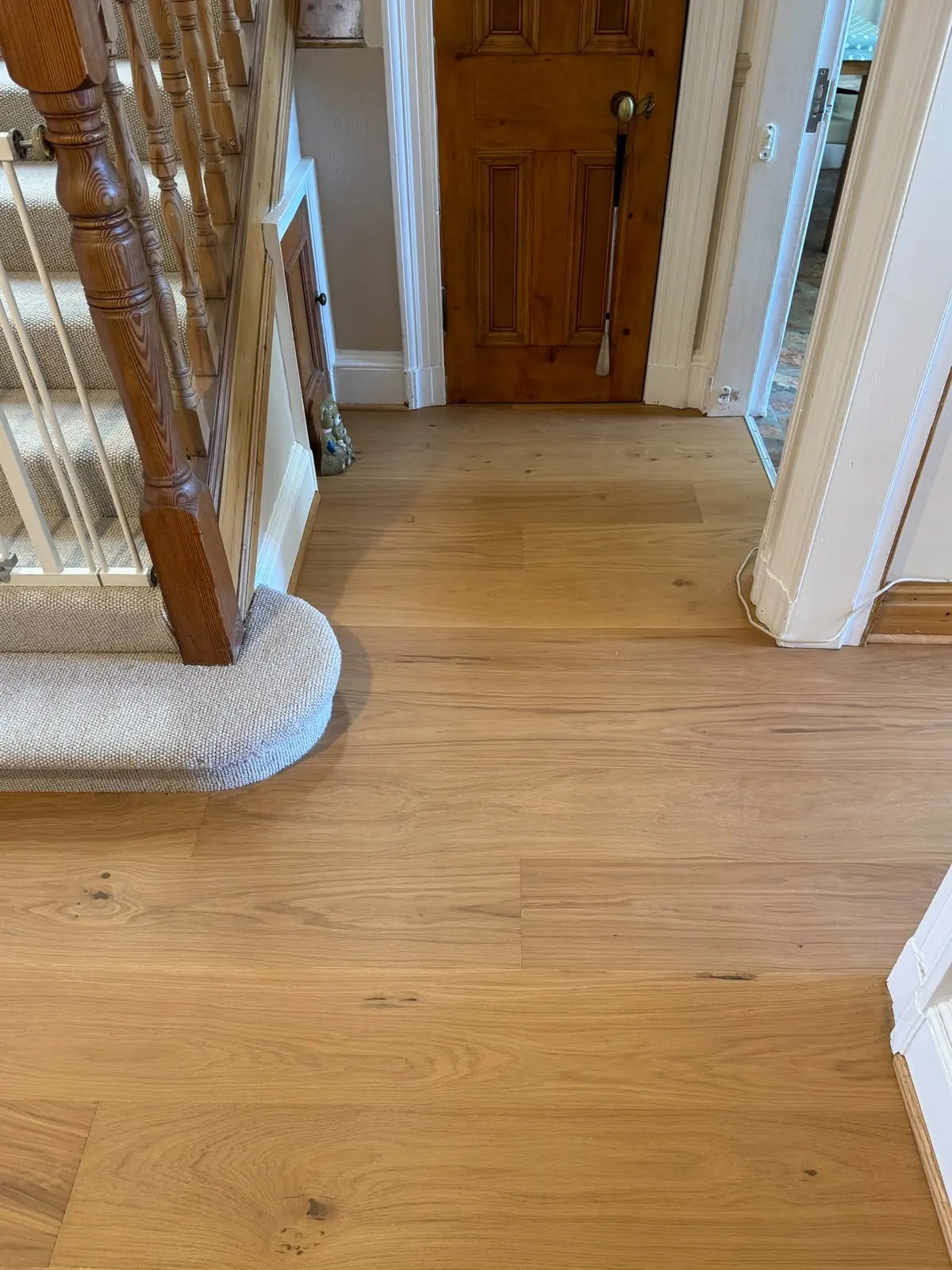 Engineered oak planks fitted around the staircase and undercut doorways