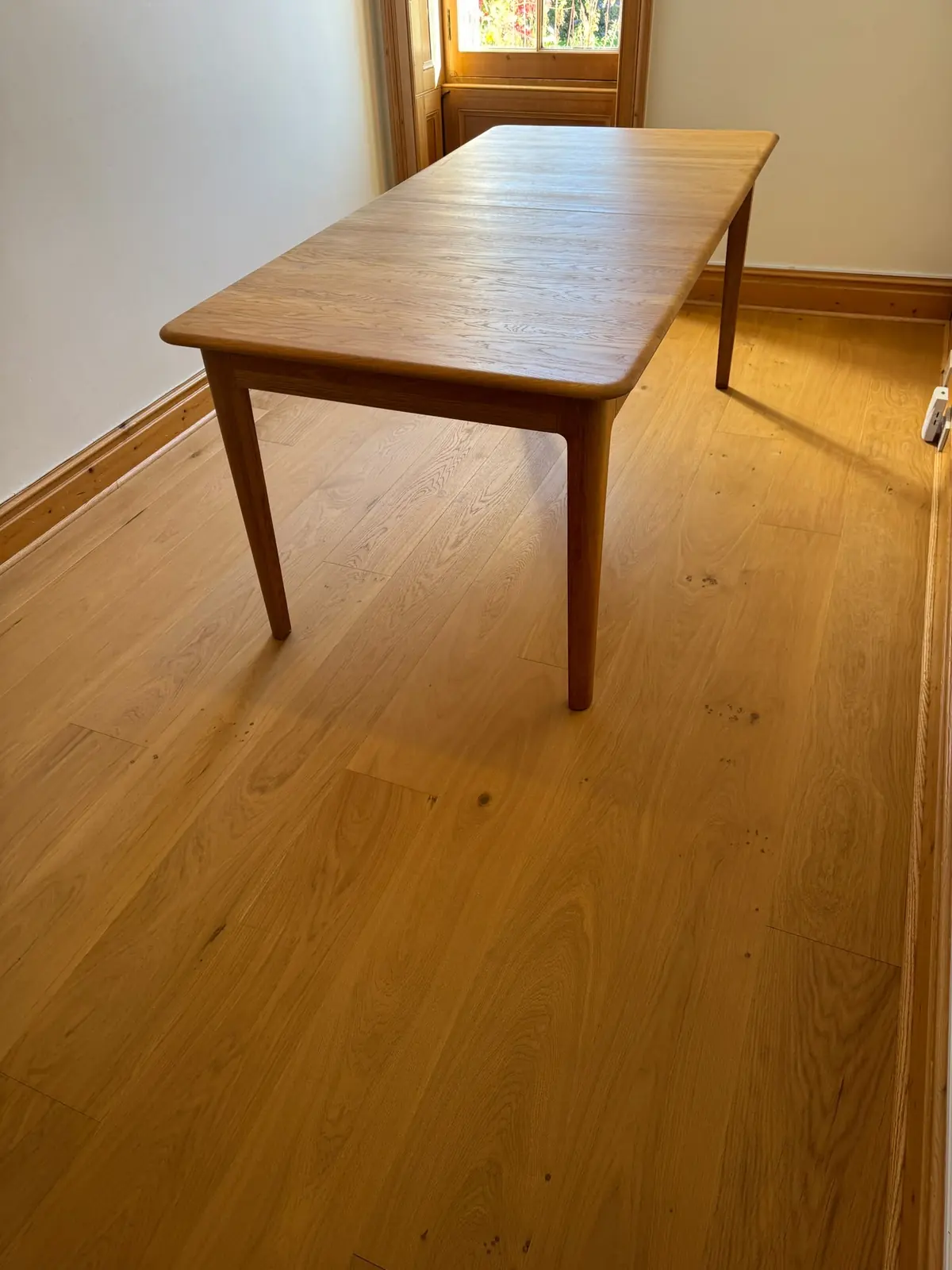 Old Beryllium 1 oak flooring in a small dining room with a period window