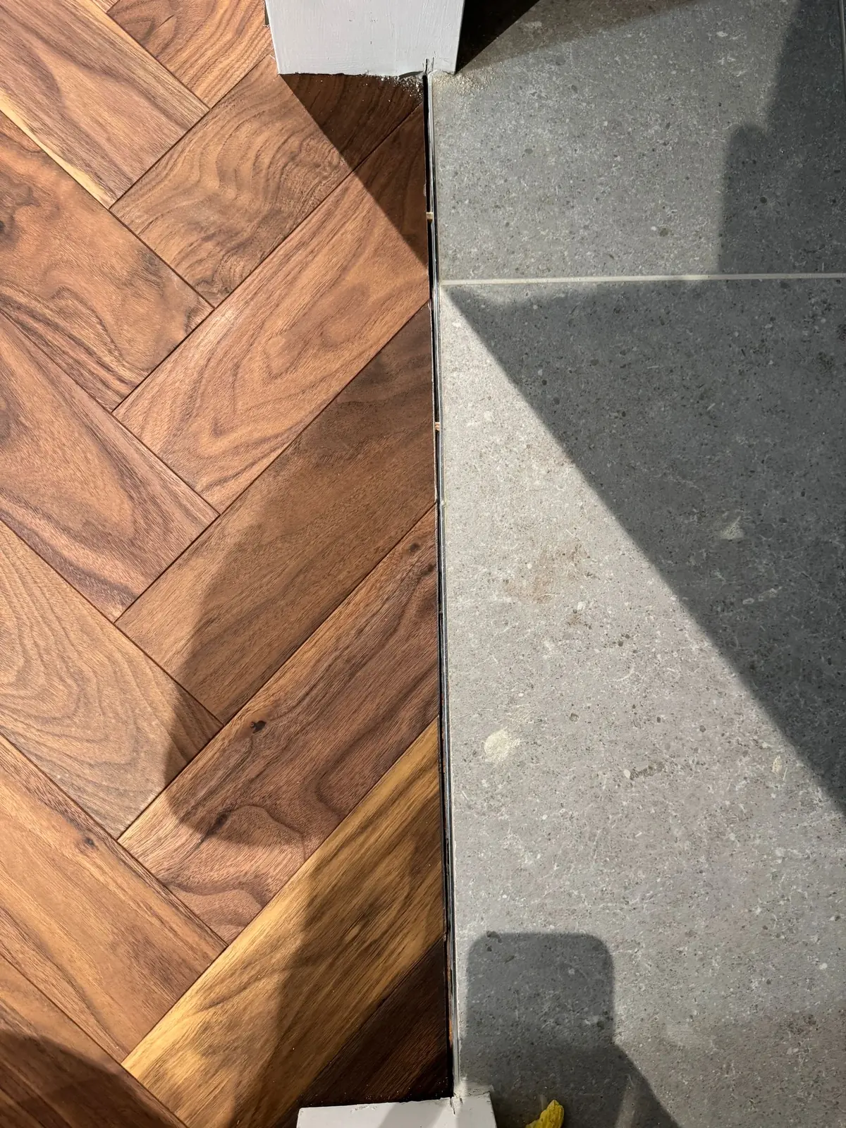American black walnut herringbone parquet in a panelled room with sash windows, central London