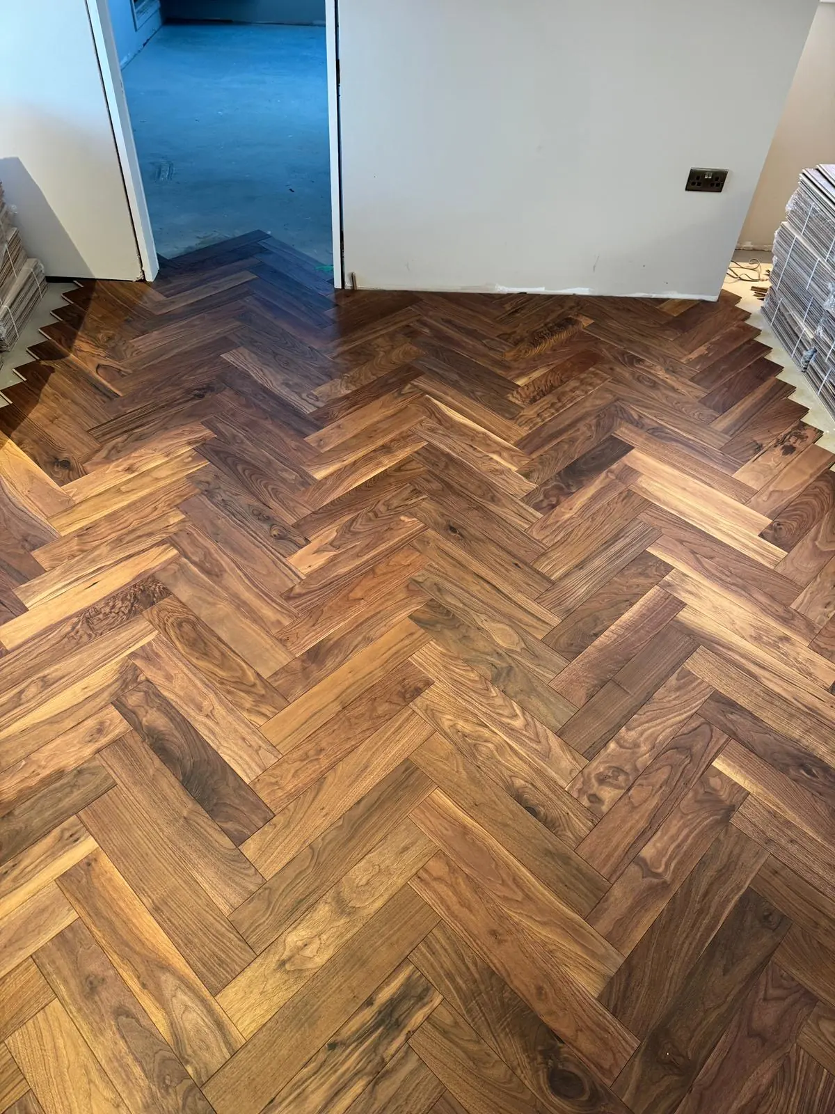 Engineered walnut herringbone bedroom floor in central London