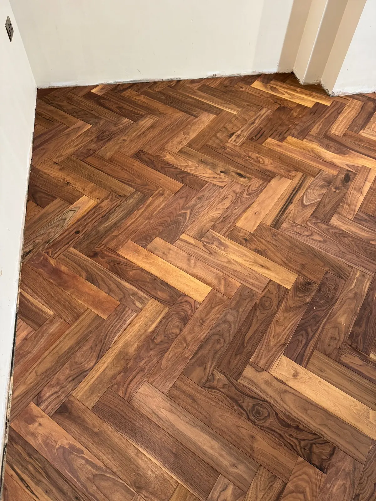 Natural colour variation across American black walnut herringbone blocks